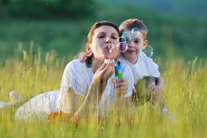 Mother and child blowing bubbles